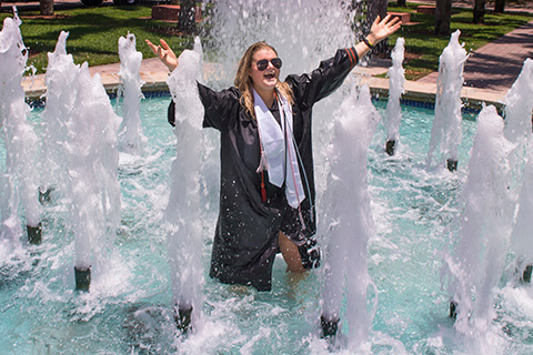 Grad celebrating in the fountain