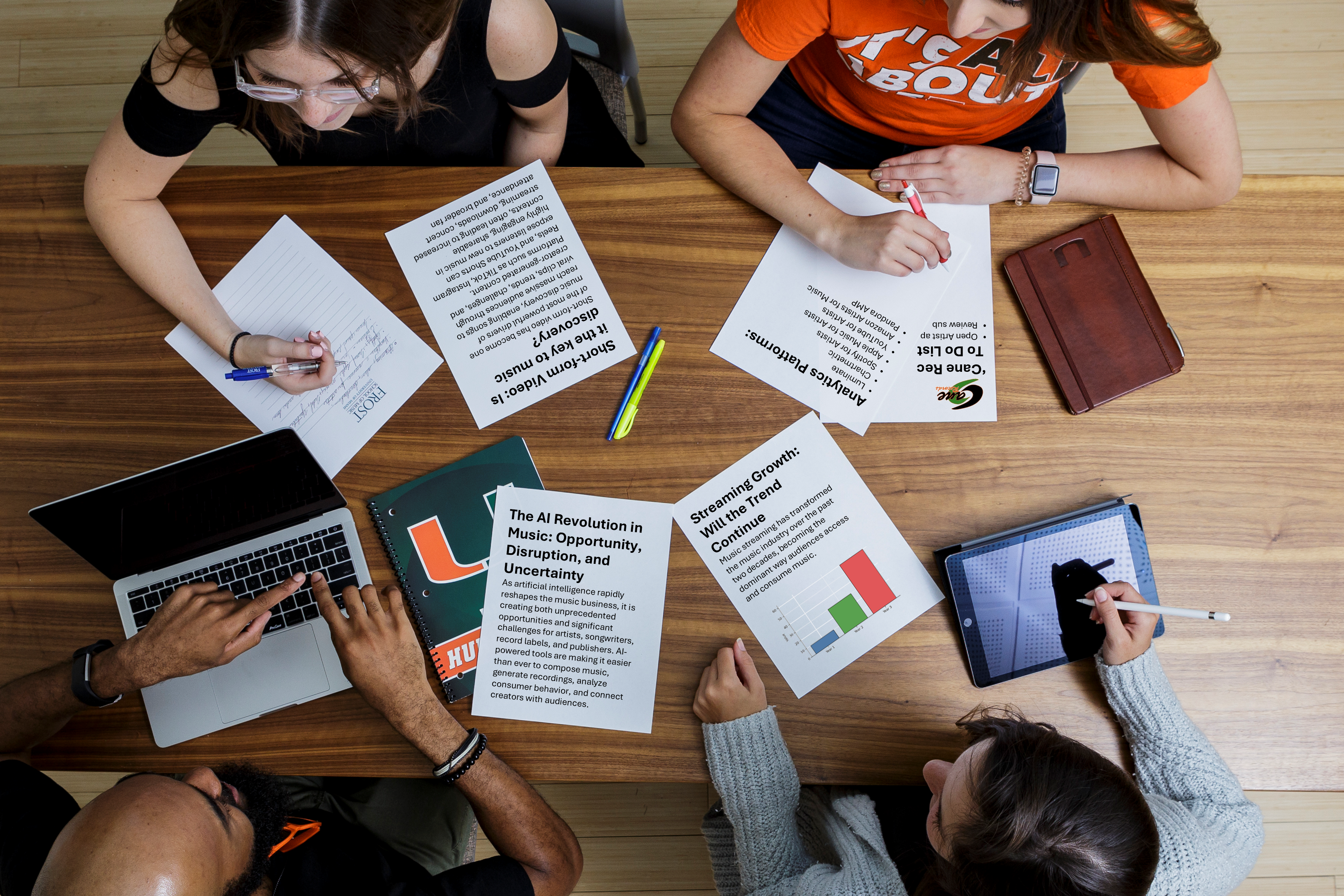 Students studying with papers notebooks and computers